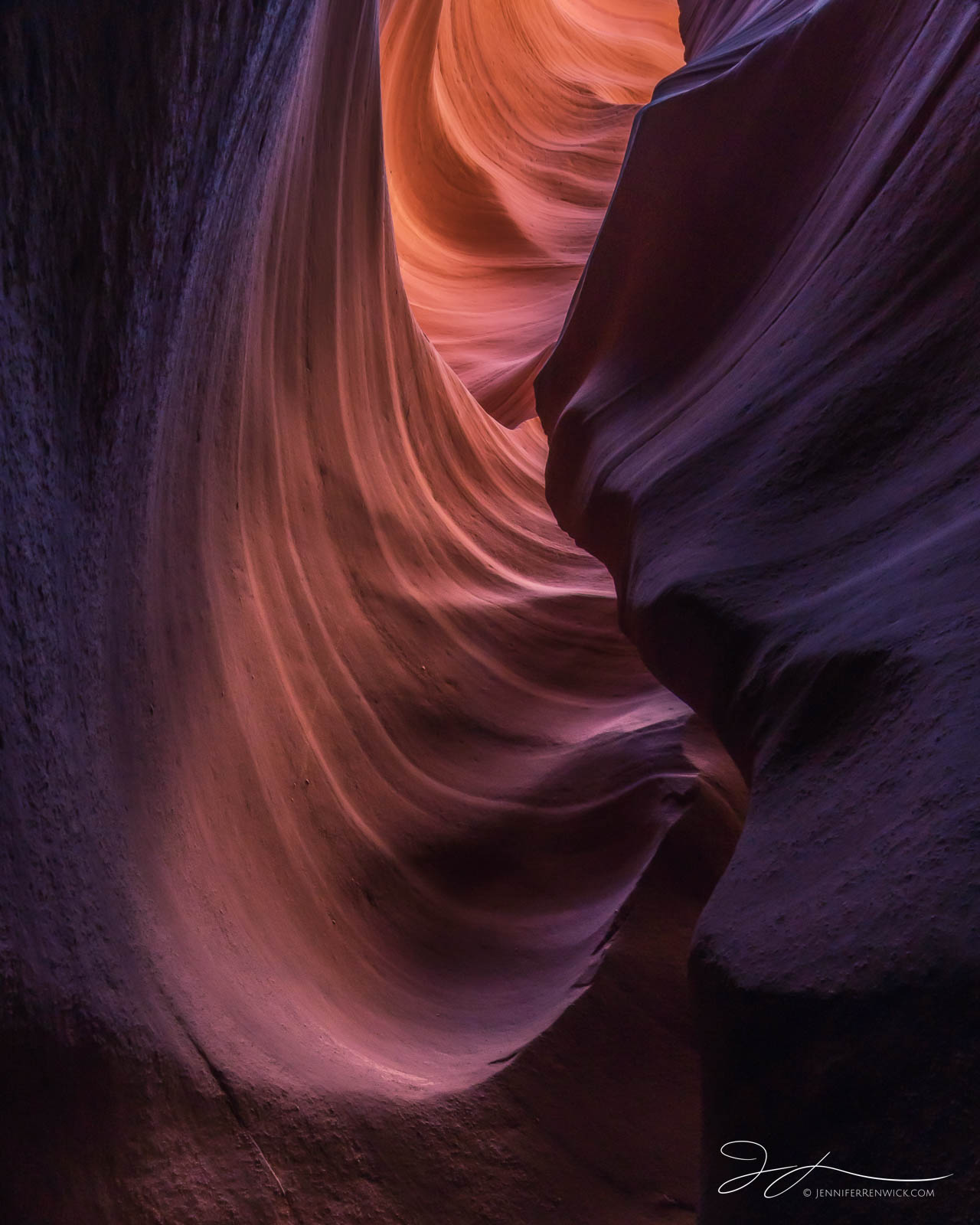 Colors glow in a crevice of a slot canyon.