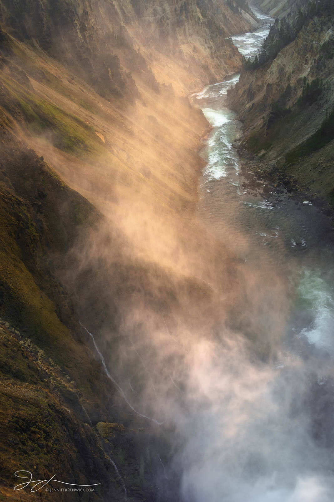 Mist from the Lower Falls illuminates in the early morning sun as it dissipates into the Grand Canyon of the Yellowstone.