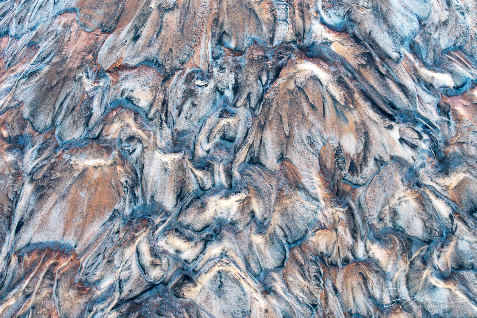 Sand creates a chaotic pattern after a flood in the desert.