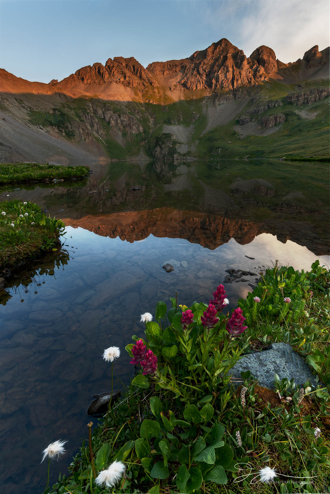 A high alpine lake catches the first light of morning.