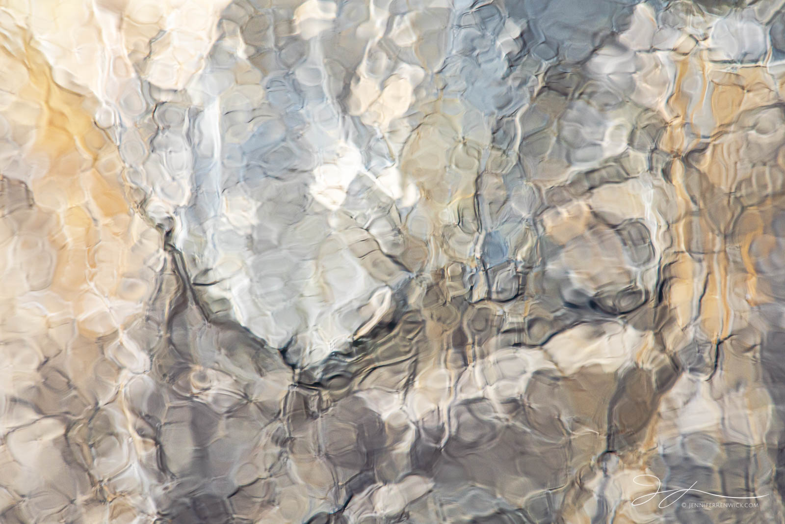 El Capitan reflects in a patch of disturbed water in the Merced River in Yosemite National Park.