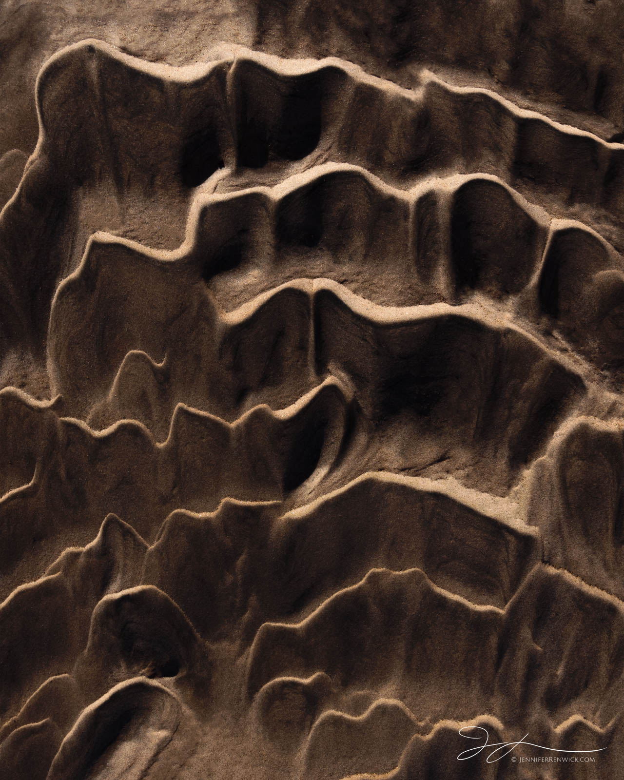 Desert sand ripples on the desert floor resemble corrugated cardboard.