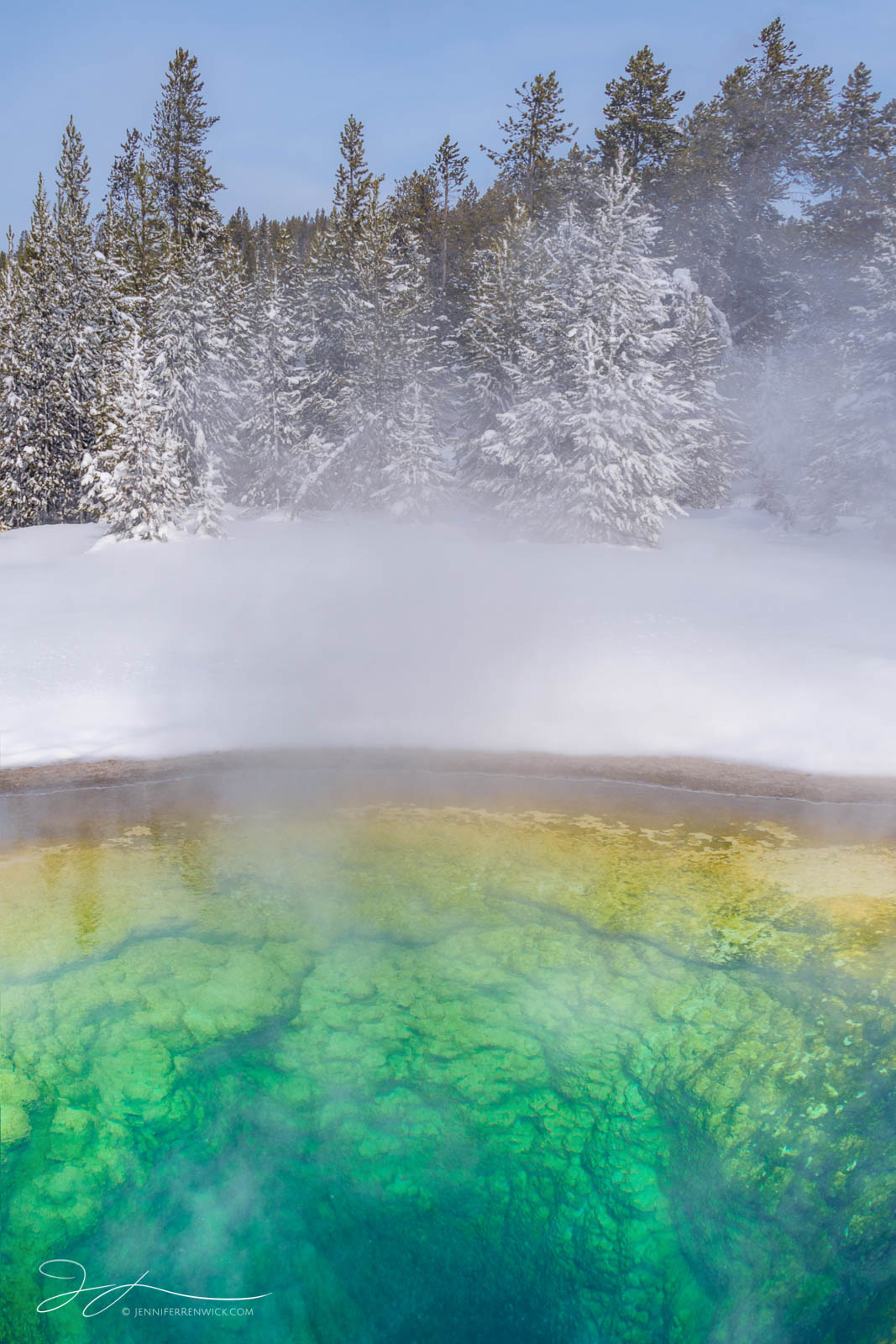 A hot spring in winter resembles a cross-section, seeming to reveal the underground of the landscape.