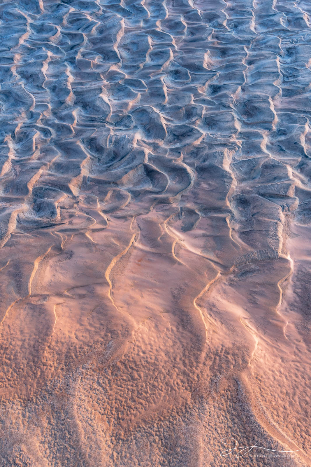 A ripple pattern appears to dissolve into the desert floor.