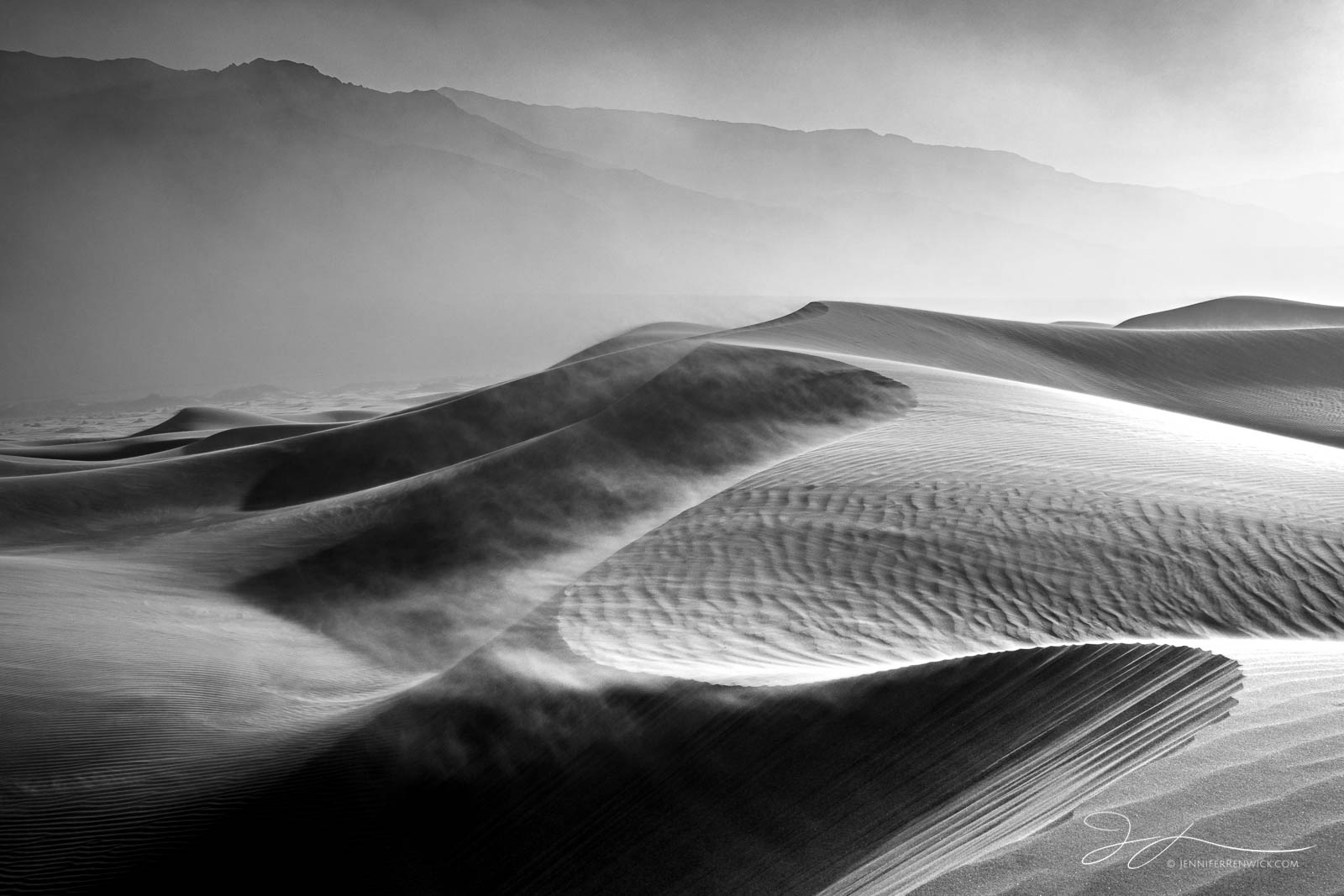 The wind whips sand into the atmosphere and across the dunes during an afternoon windstorm.