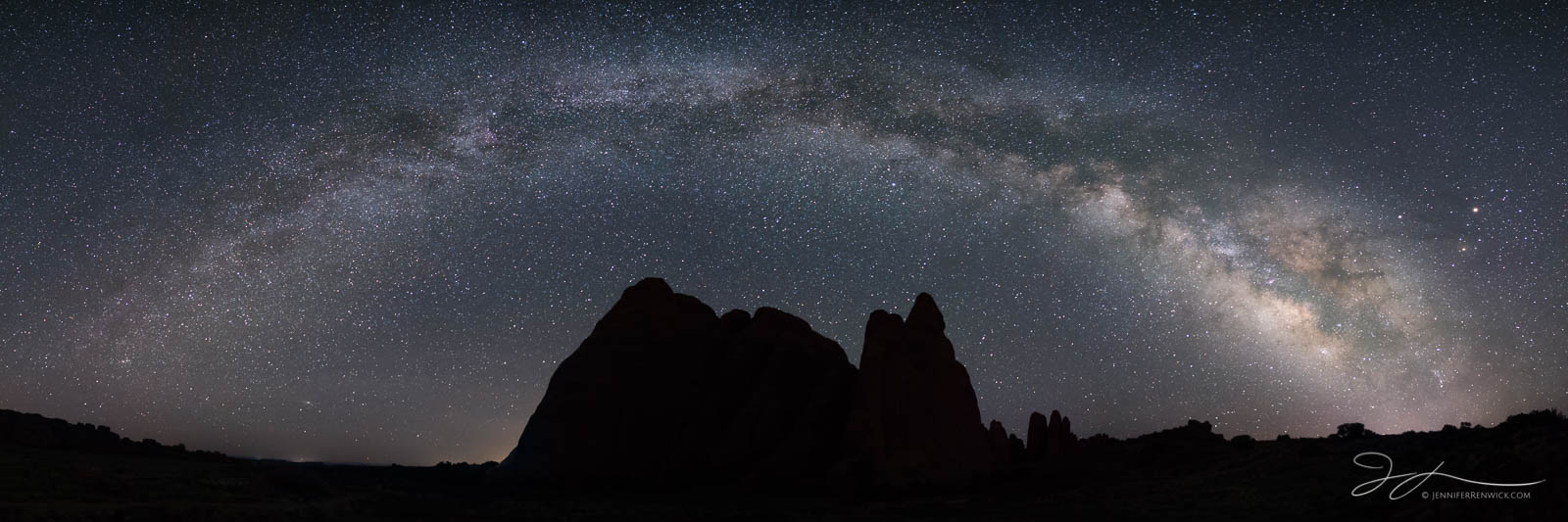 The Milky Way arches above the Fins in Arches National Park.