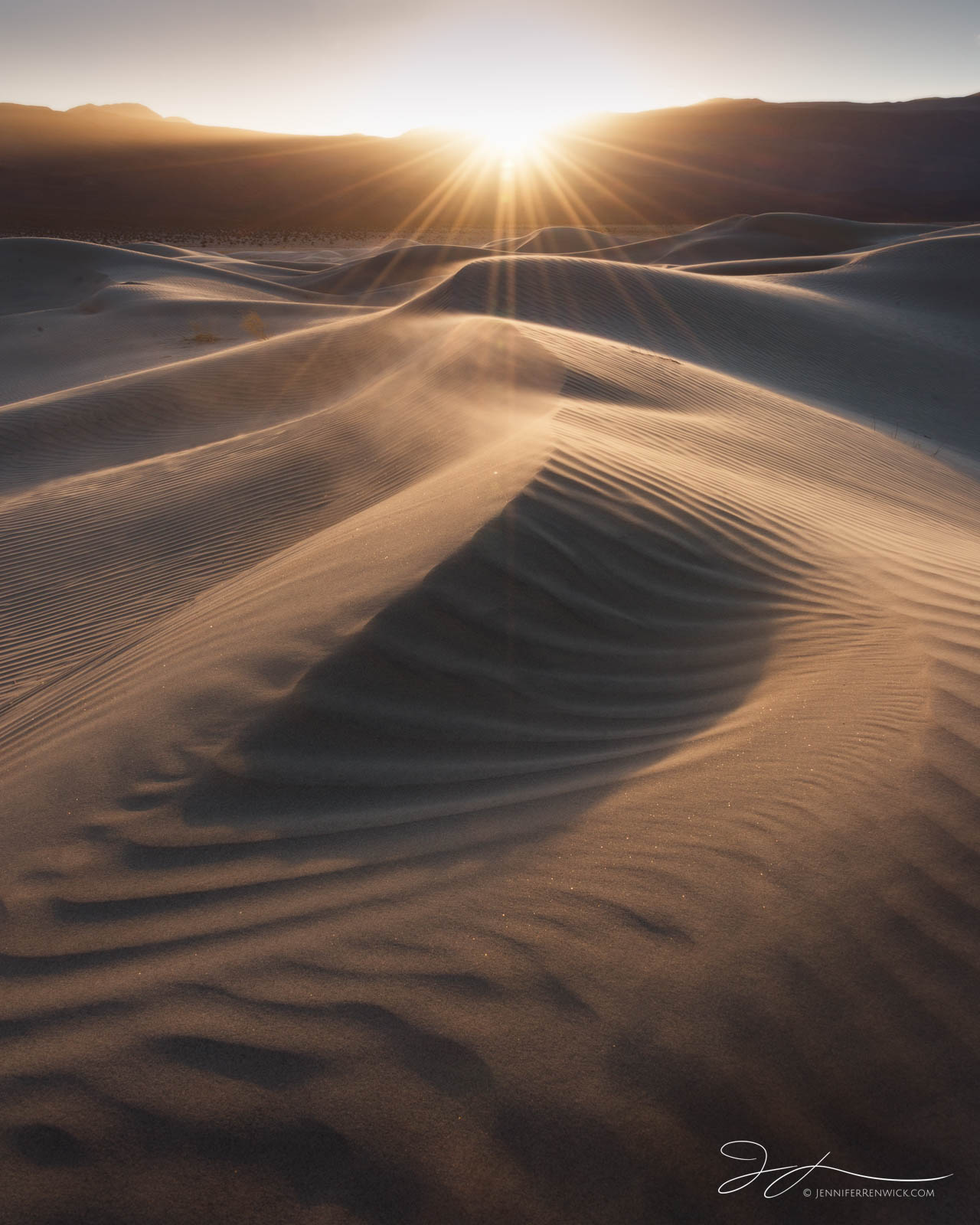 The sun sets over a remote dune field in Death Valley National Park.