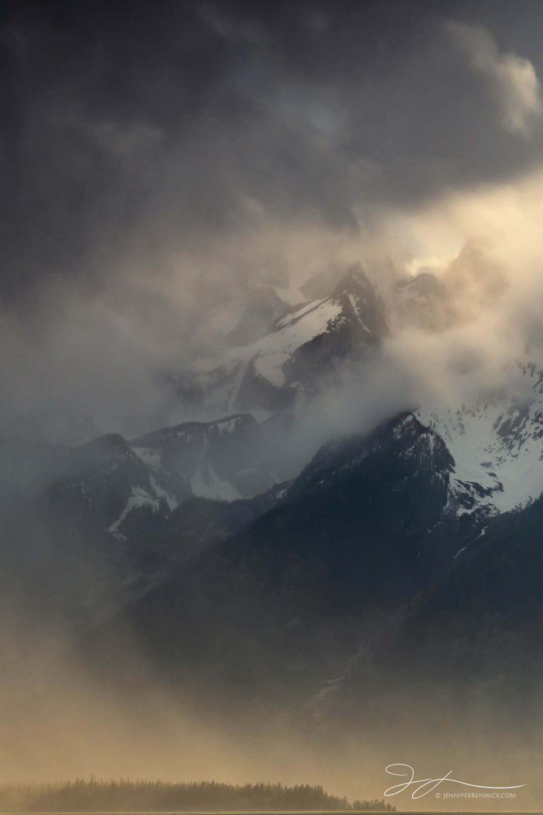 A clearing storm reveals the peaks in the Teton Mountain Range.