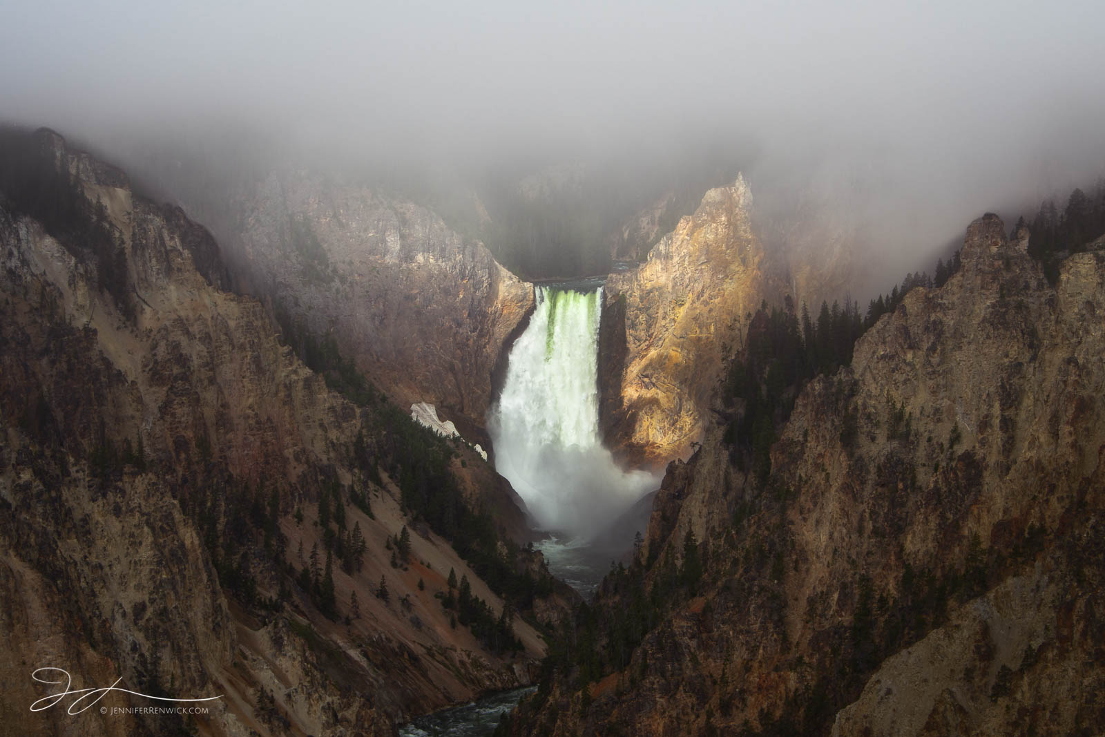 The morning sun spotlights the Lower Falls as clouds and fog clear.