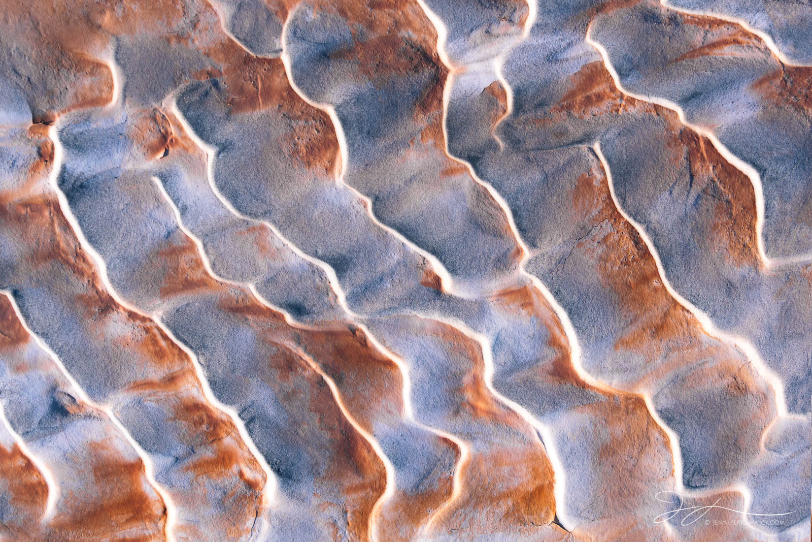 Sand ripples create a textured surface on the desert floor.