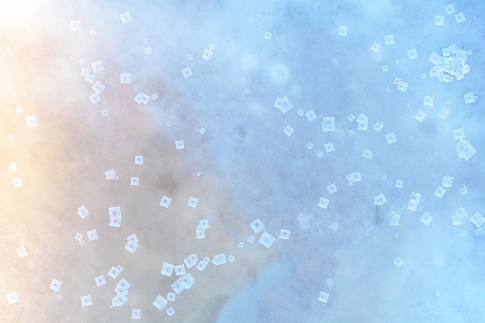 Salt Fantasy Salt crystals float in a pool reflecting dreamy warm and cool light.