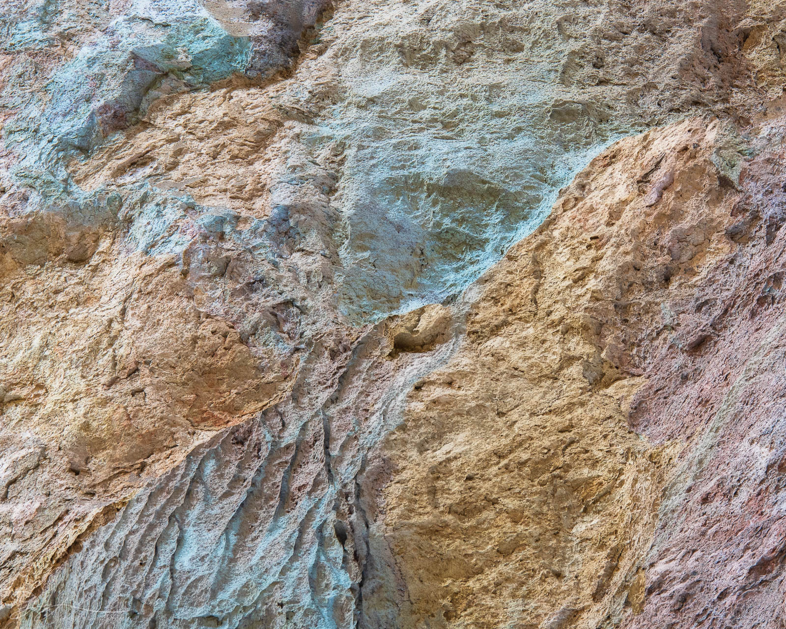 Sherbet Colorful rocks meld together on a canyon wall.