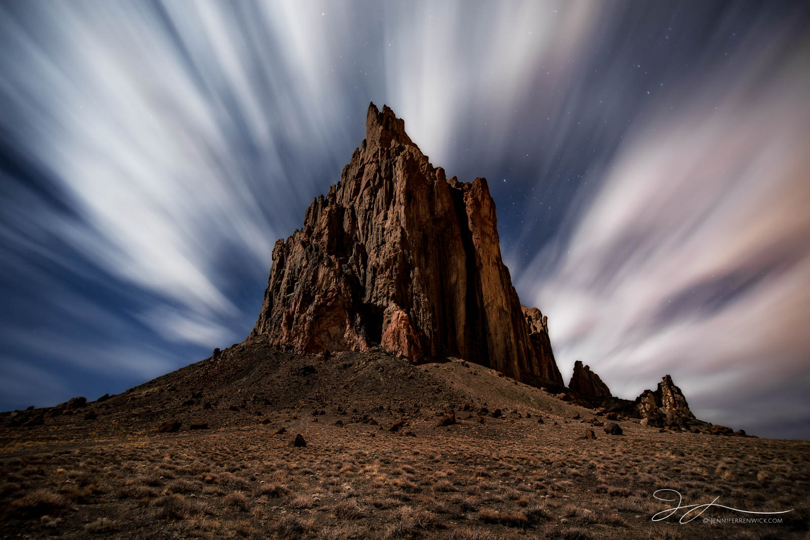 Shiprock catches light from the moon while a longer exposure creates magical cloud movement.