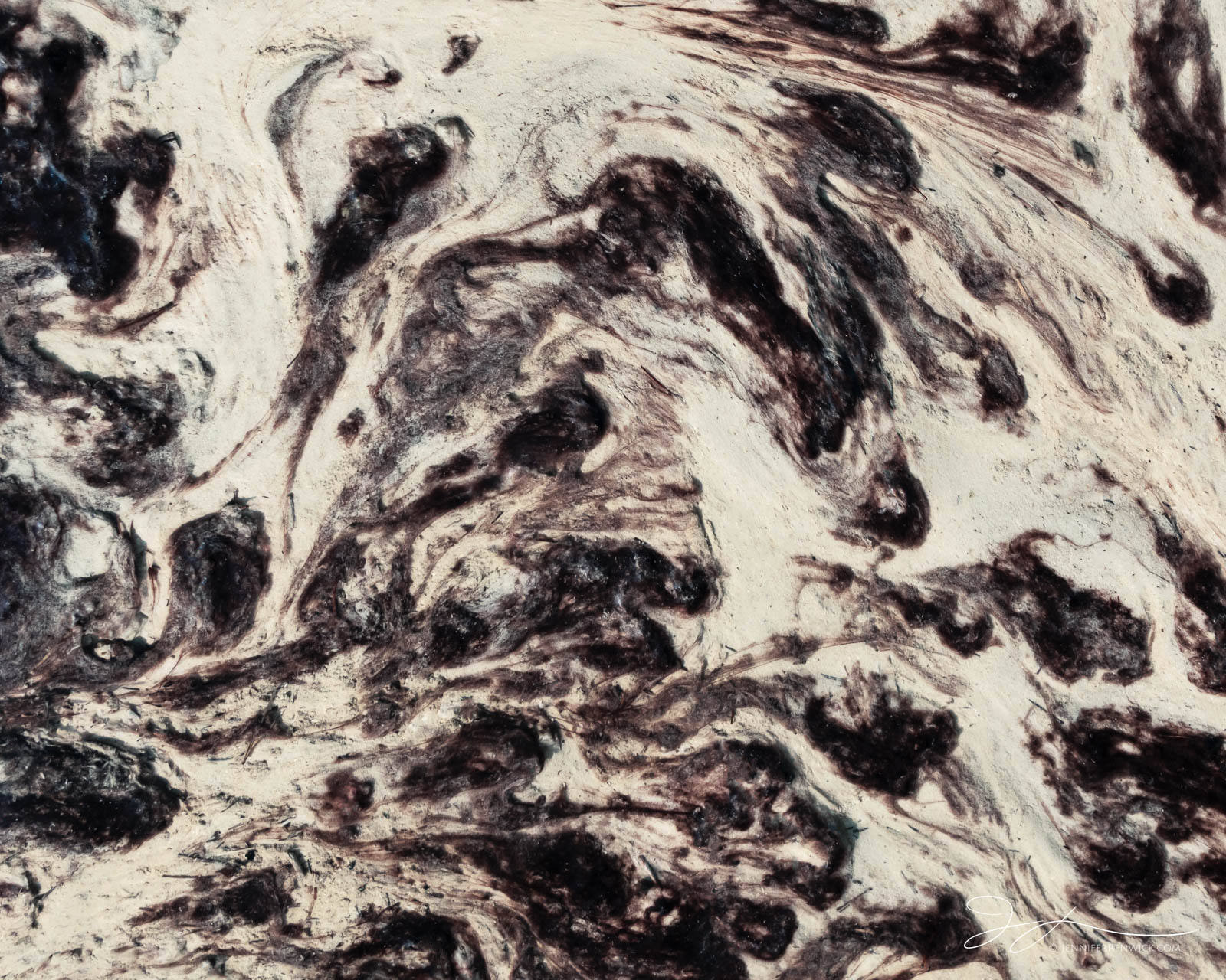 Bacterial mats appear to swirl in a small thermal stream in Norris Geyser Basin.