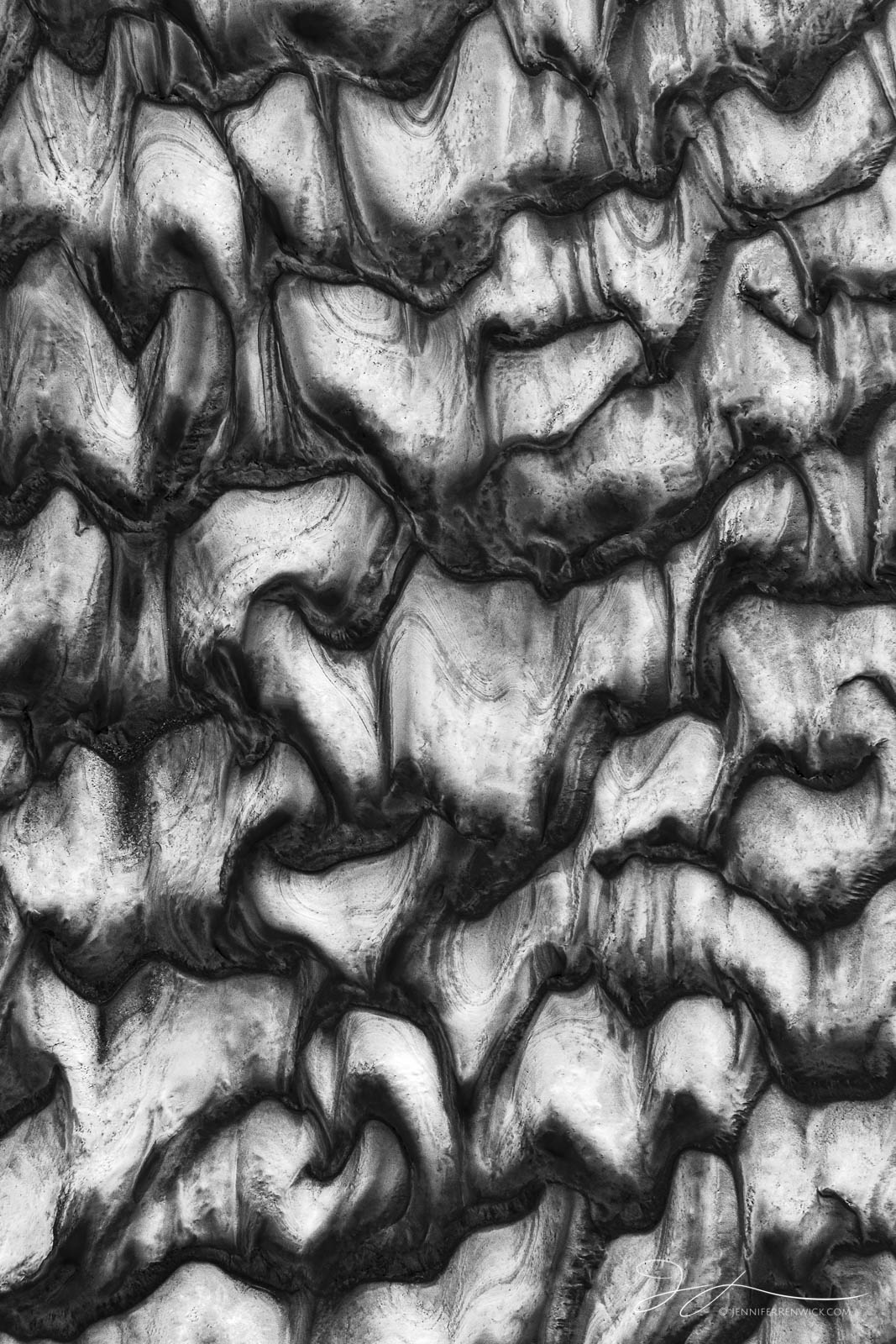 A dried mudflow creates an area of texture on the desert floor.