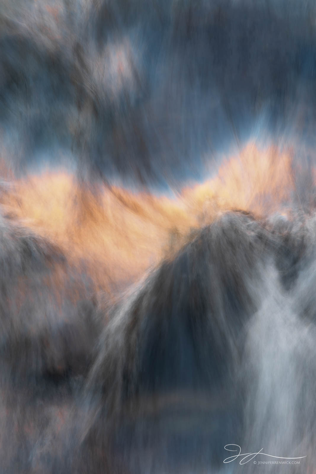 The canyon skyline reflects in a stream in Zion National Park during a long exposure.