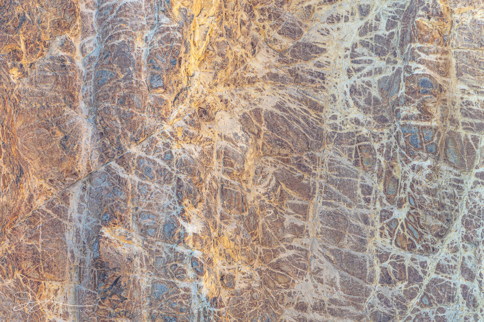 Fractures and patterns cut across the hydrothermally altered rhyolite walls of the Grand Canyon of the Yellowstone.